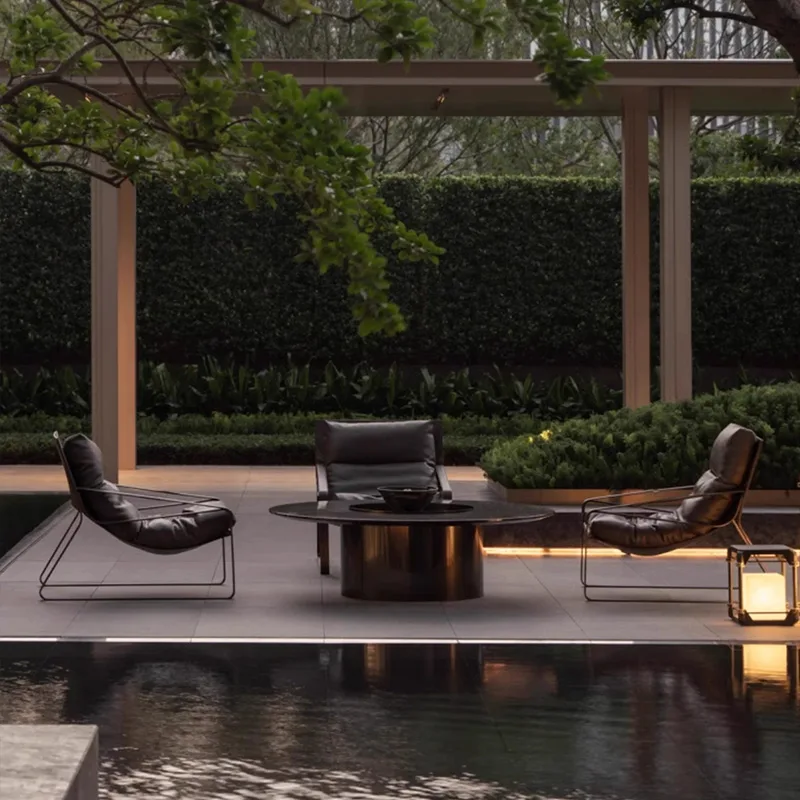 Outdoor Lounge Chairs by Pool Outdoor lounge chairs and round table beside a pool