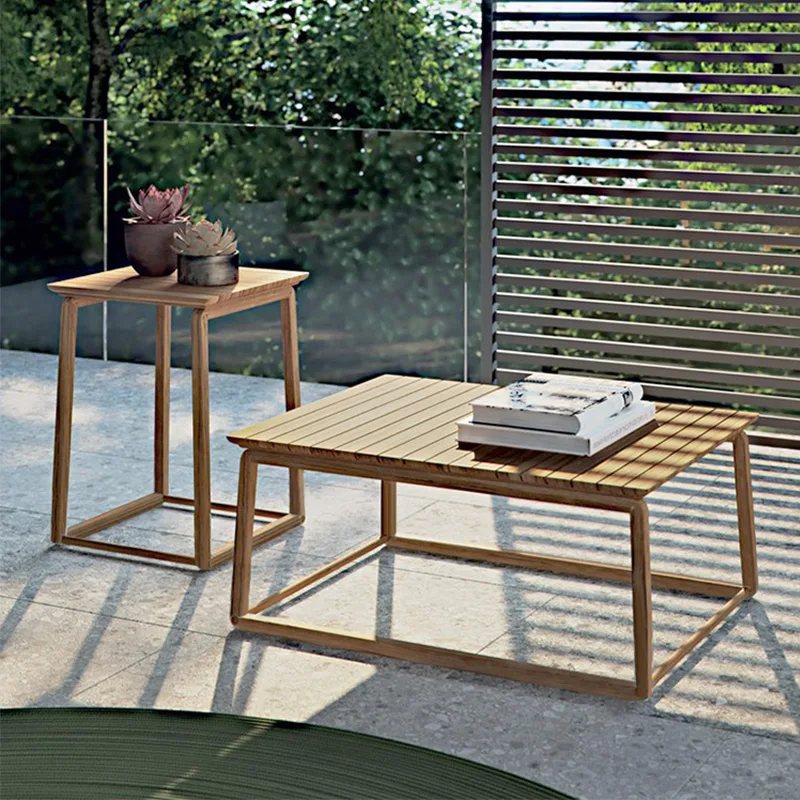 Outdoor Teak Coffee Table Outdoor teak coffee table set on a patio